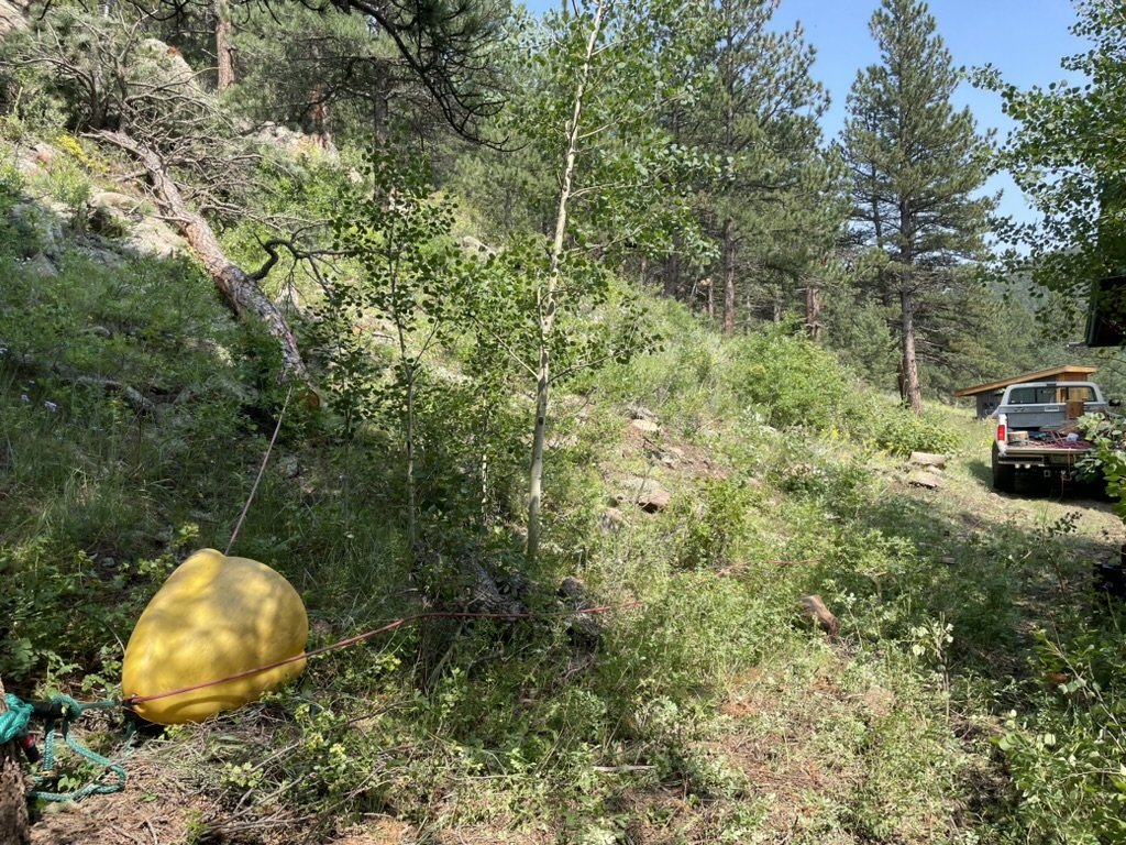 Thinning work on a forested foothills slope with the rigging bag staged nearby